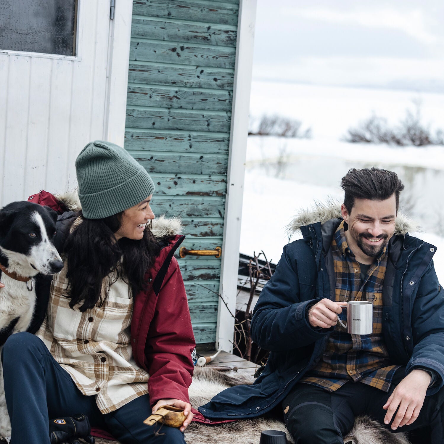 couple enjoying coffee on snowy environment 