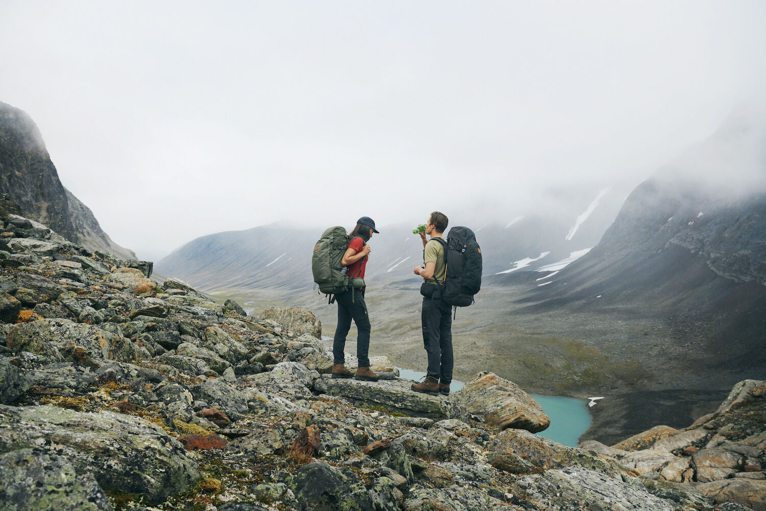 two men taking a break while trekking on mountain