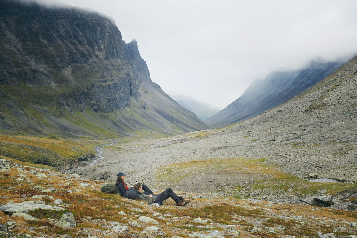 two men taking a break while trekking on the mountain