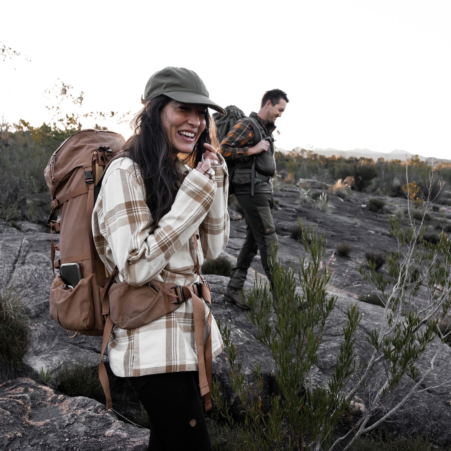 couple in long sleeve shirt hiking on rocky mountain
