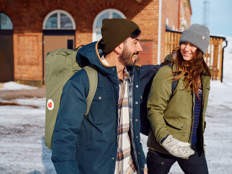 couple walking on snowy surface 