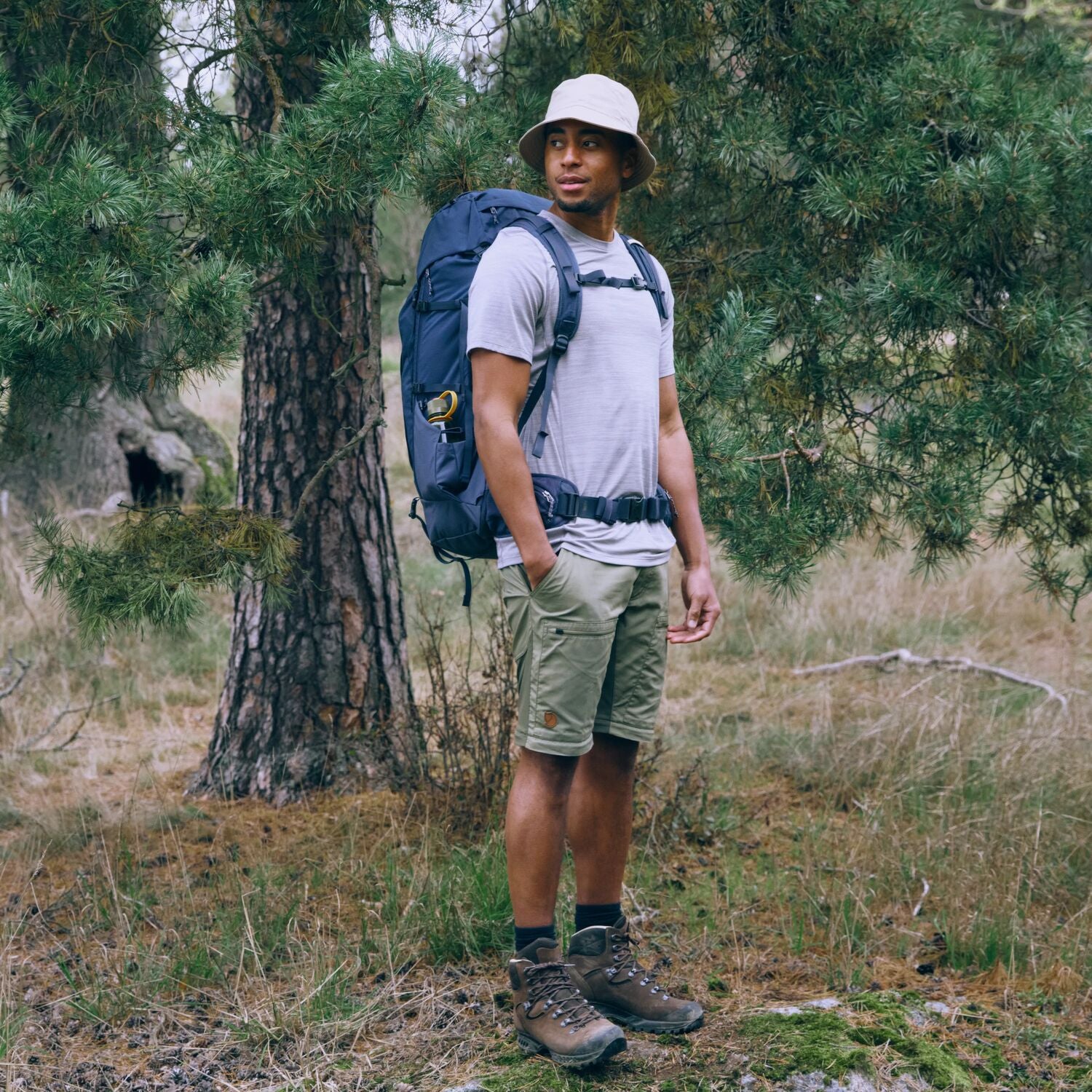Man with a backpack standing in a forest
