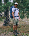 Man with a backpack standing in a forest