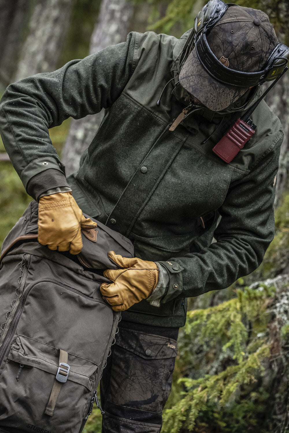 Person in outdoor gear with a backpack in a forest setting