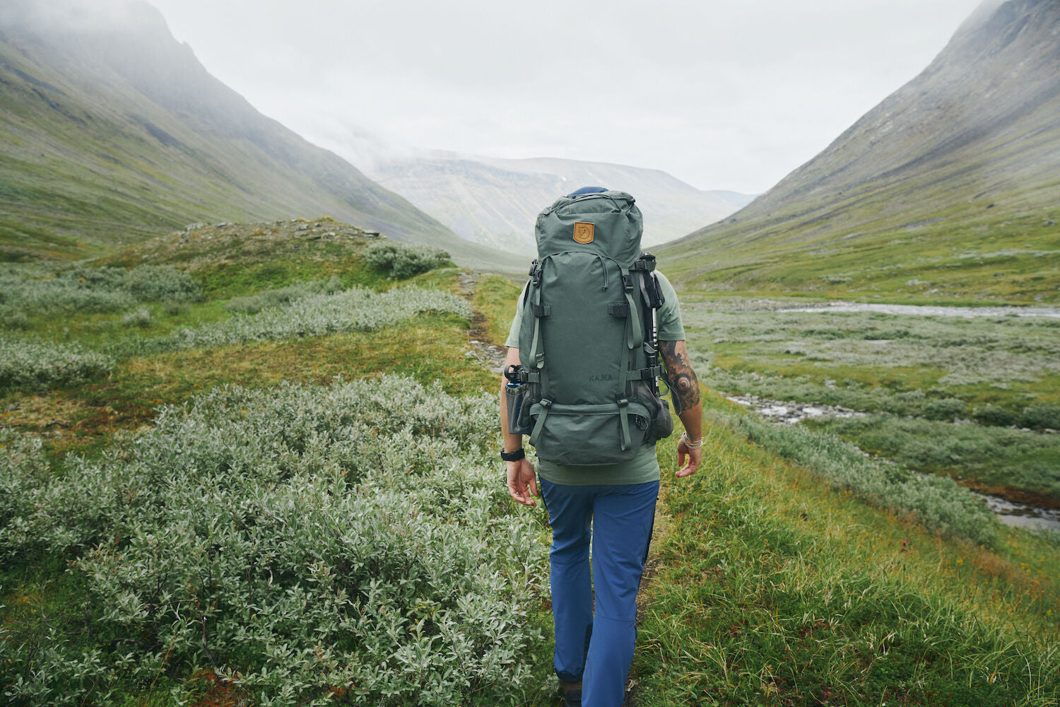 men carrying trekking backpack trekking along mountain