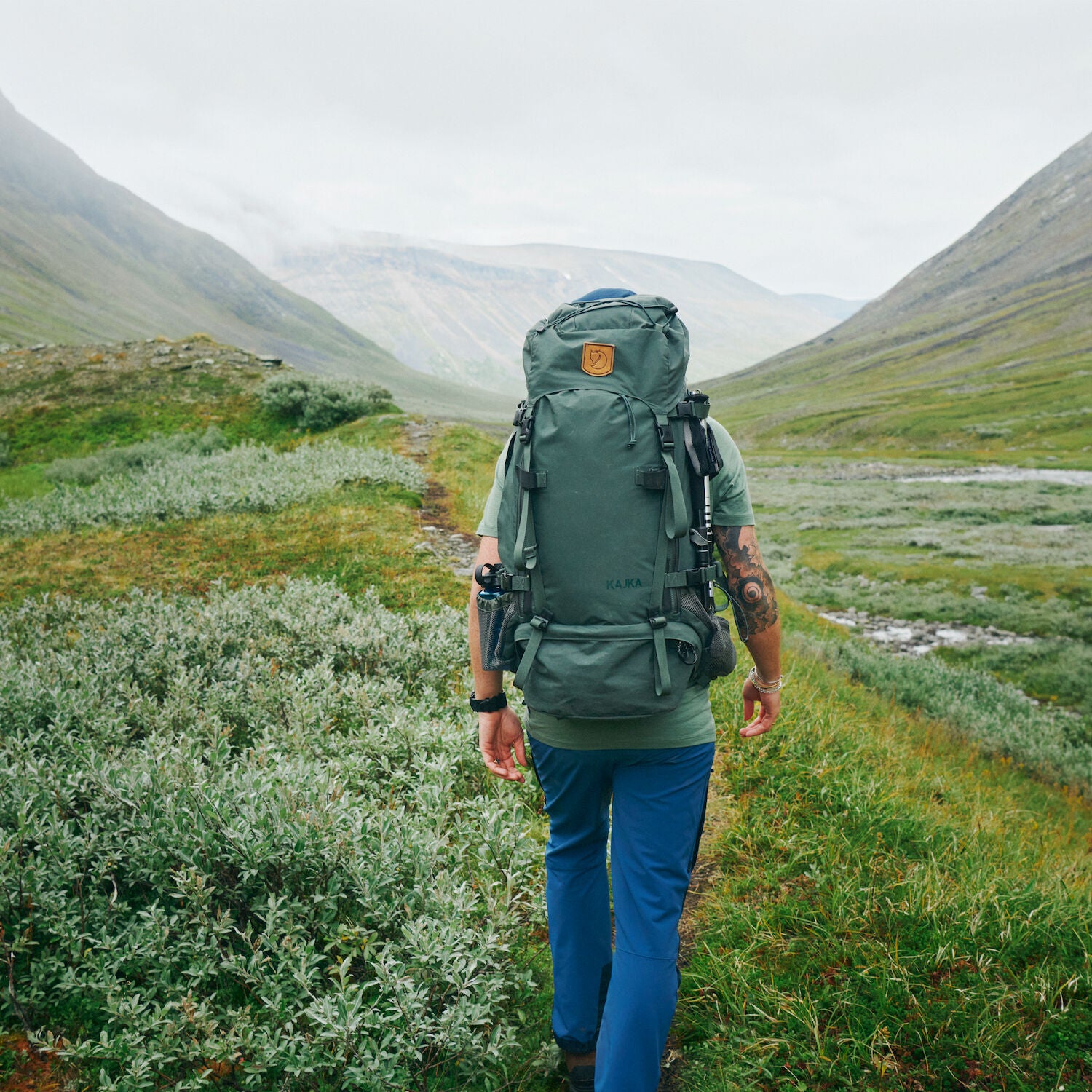 a men carrying trekking backpack trekking on a mountain
