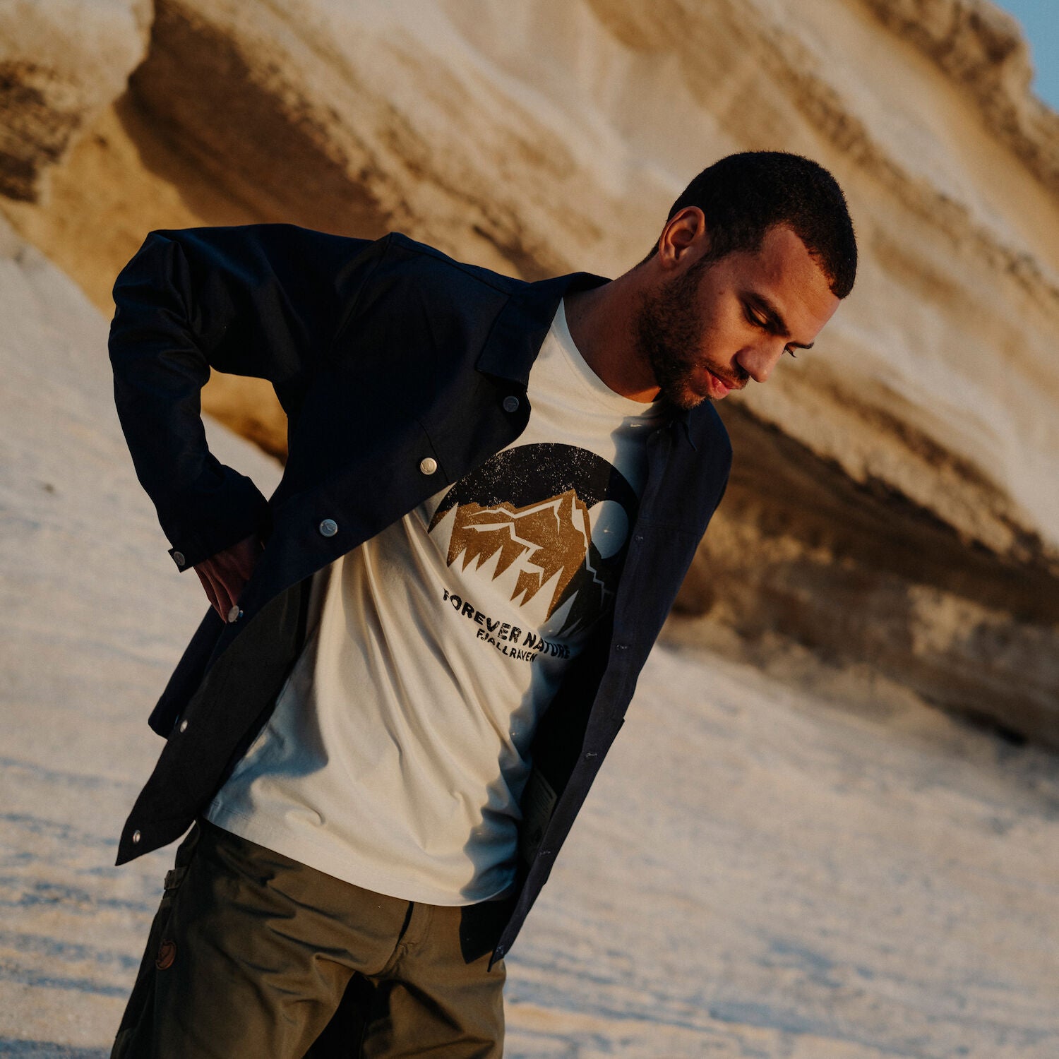 man wearing white round neck t-shirt and navy outerwear