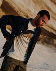 man wearing white round neck t-shirt and navy outerwear