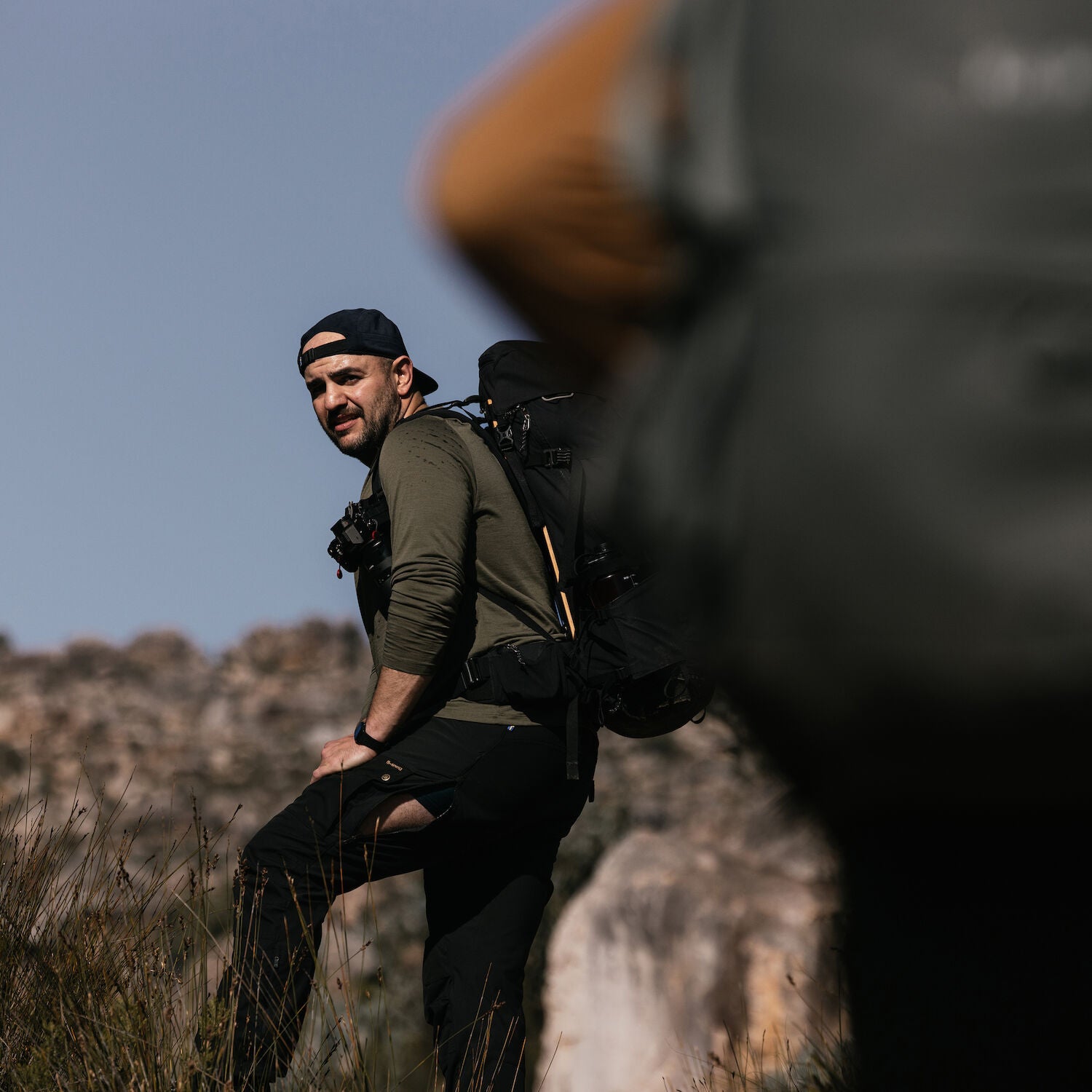 man in laurel green winter long john trekking on mountain