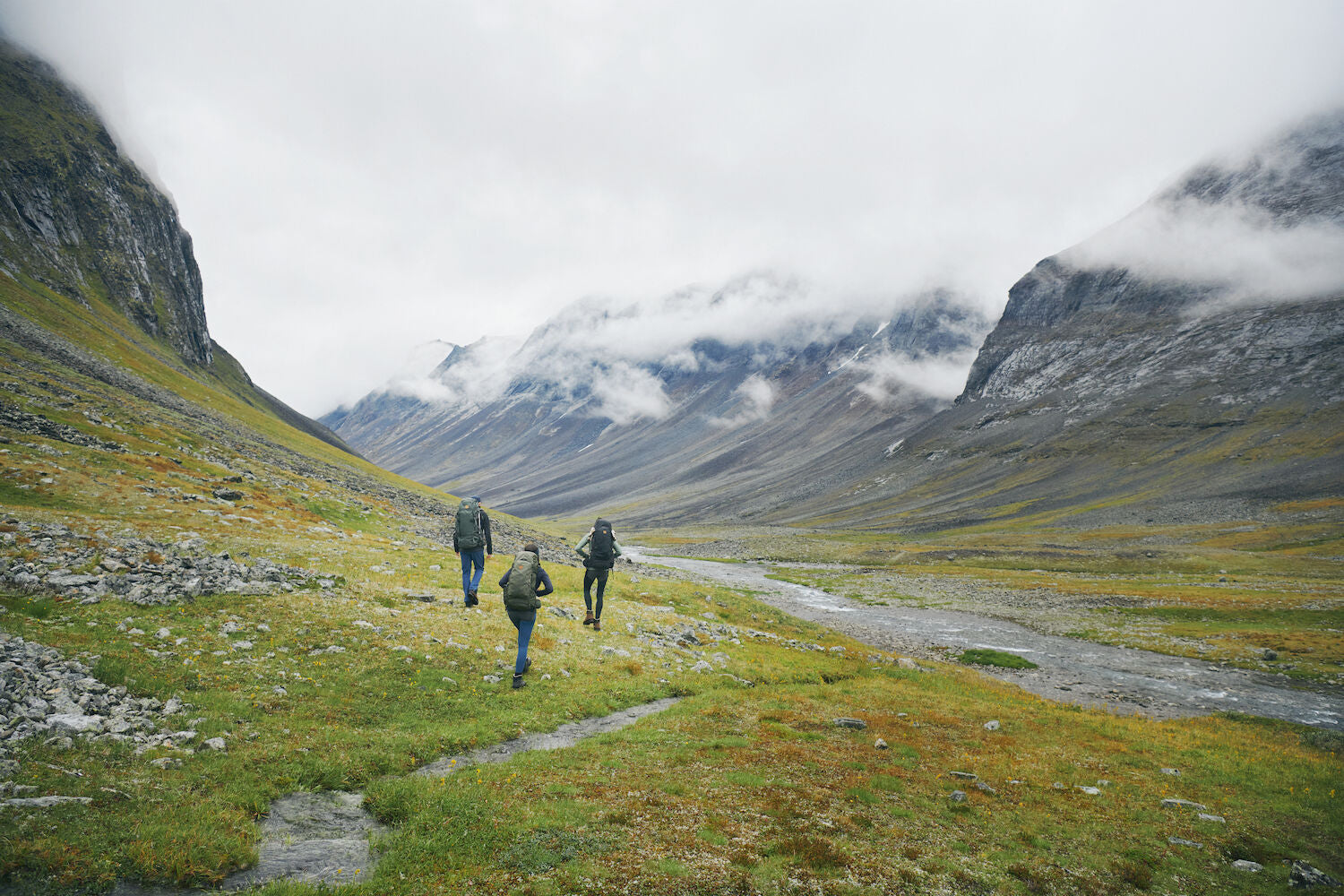 three men trekking on a mountain