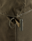 Close-up of a brown fabric with a drawstring and button, likely from a bag or pouch.