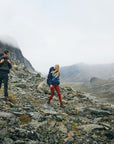 three men trekking downslope on mountain
