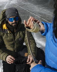 Two people in winter clothing on a frozen surface