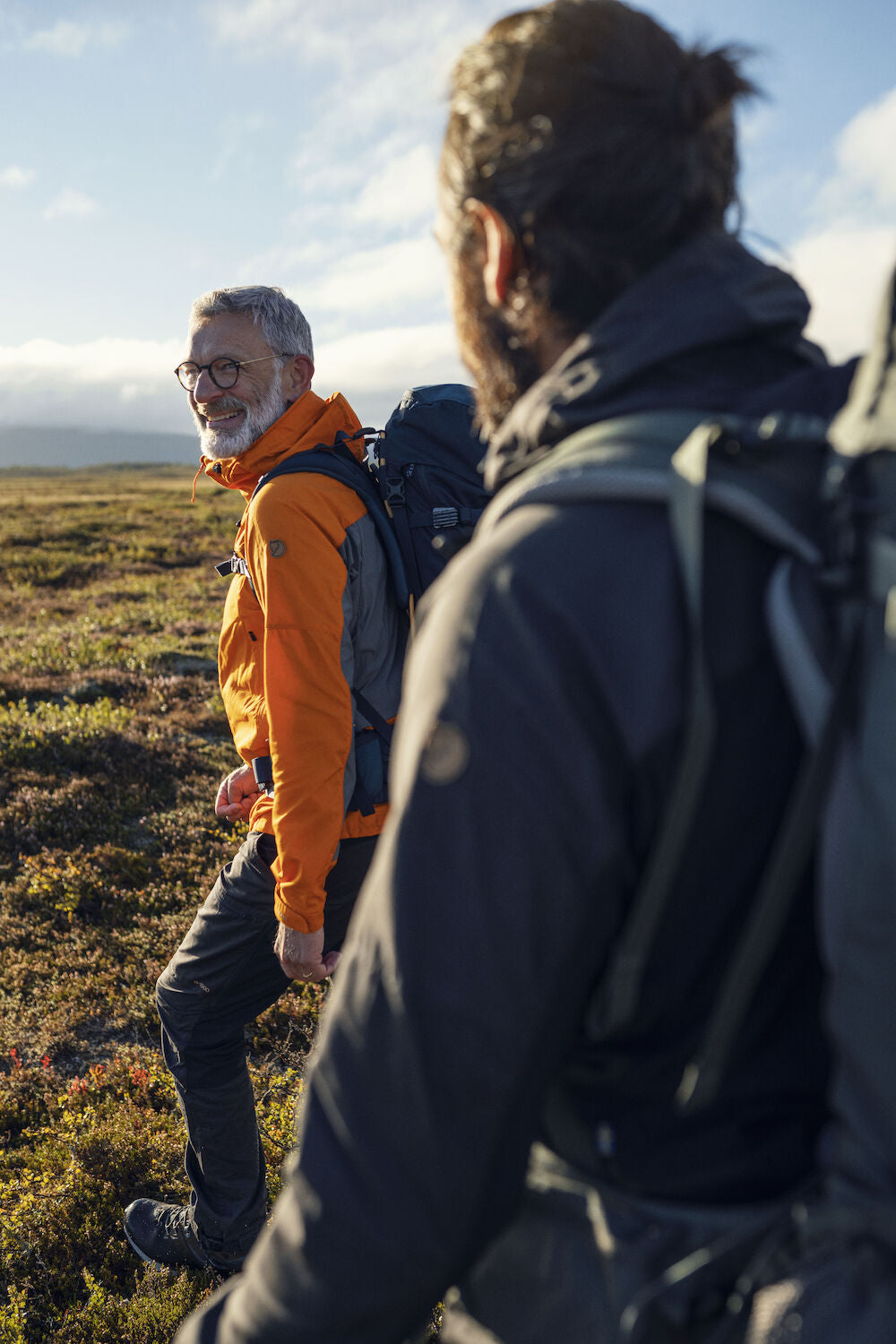 two men doing a hiking trip on grass surface