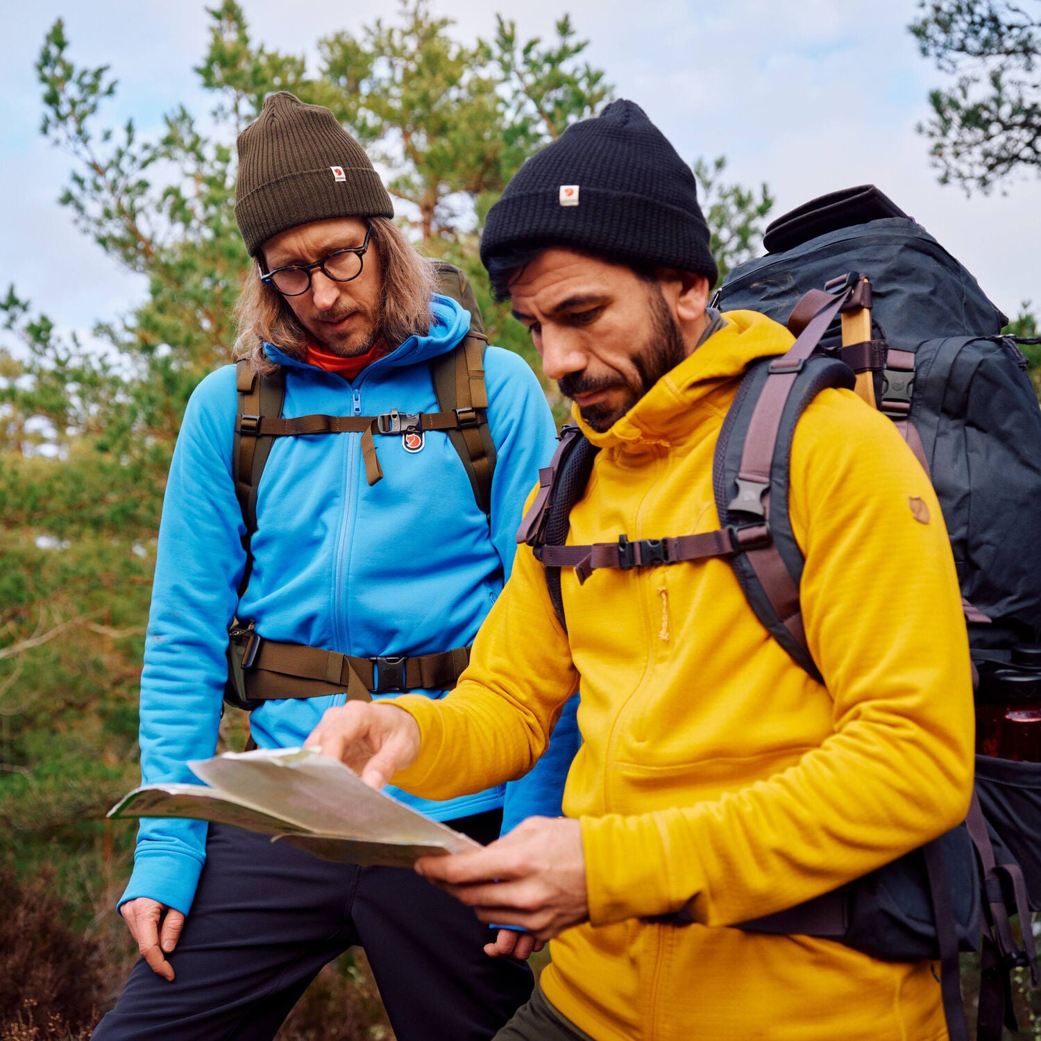 men exploring the map on a trekking trip