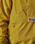 mustard yellow waterproof rain jacket with Fjällräven logo