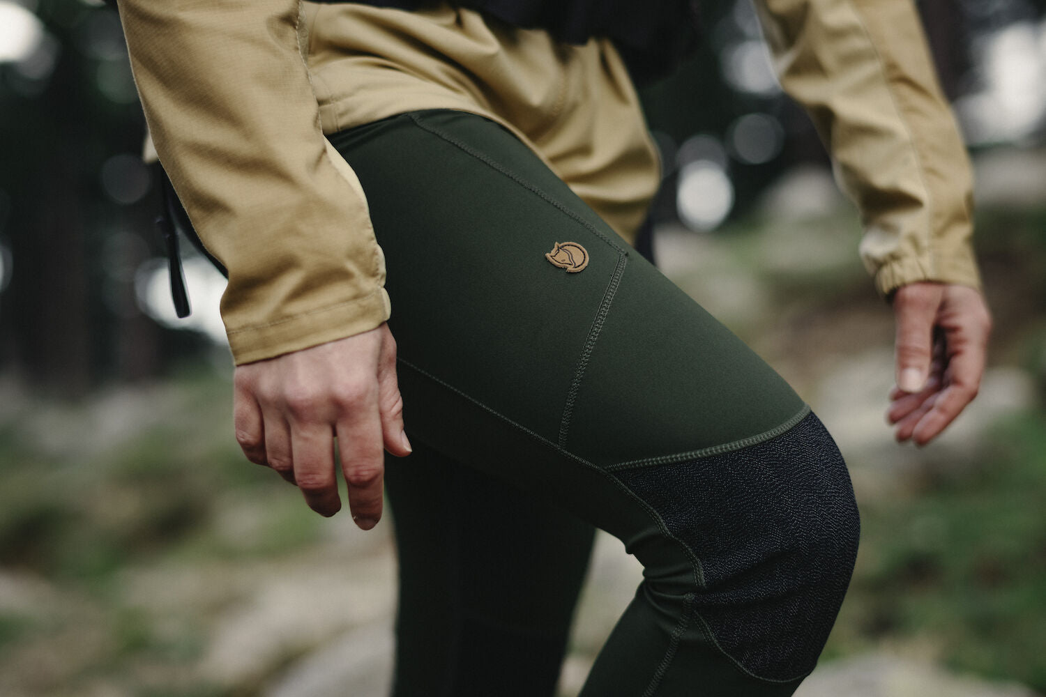 woman wearing deep forest tights with reinforced knees and Fjällräven logo