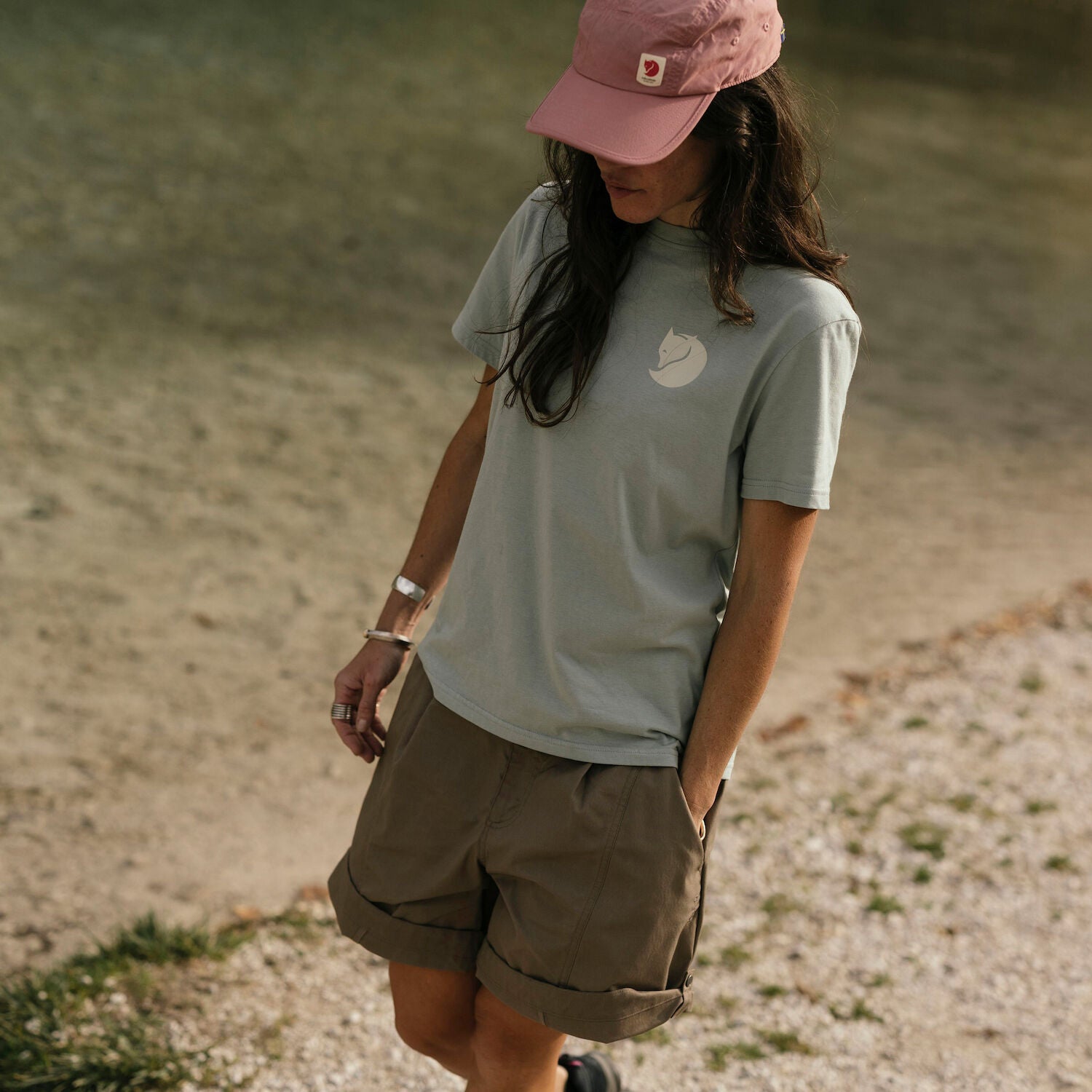 woman wearing grey  round neck t-shirt with arctic fox logo and shorts