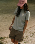 woman wearing grey  round neck t-shirt with arctic fox logo and shorts