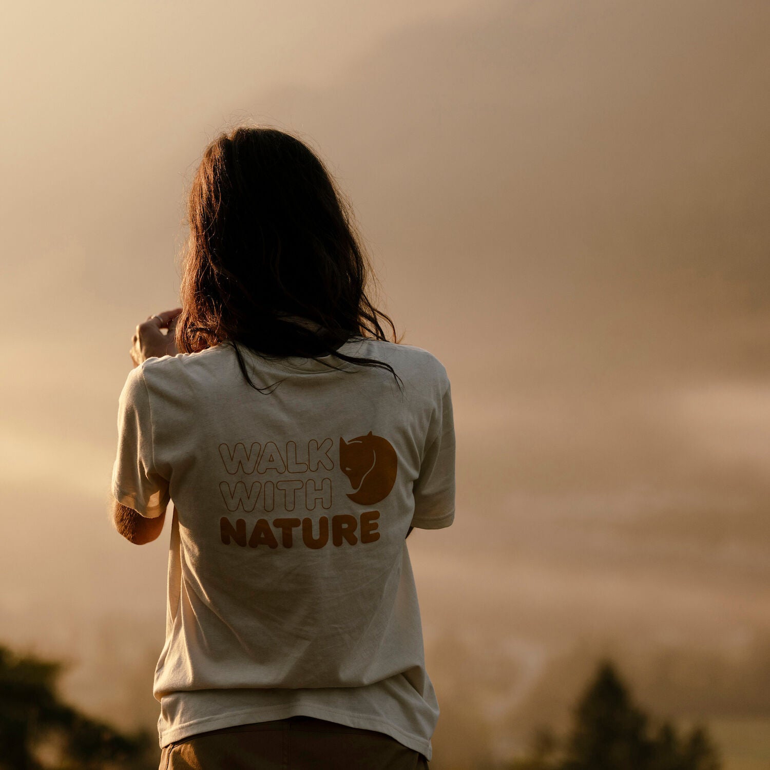 woman wearing chalk white  round neck t-shirt with arctic fox logo
